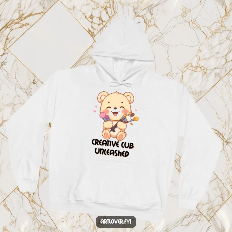 Funny artist bear cub hoodie holding a bouquet of paint brushes, offering cozy artistic inspiration and woodland charm.